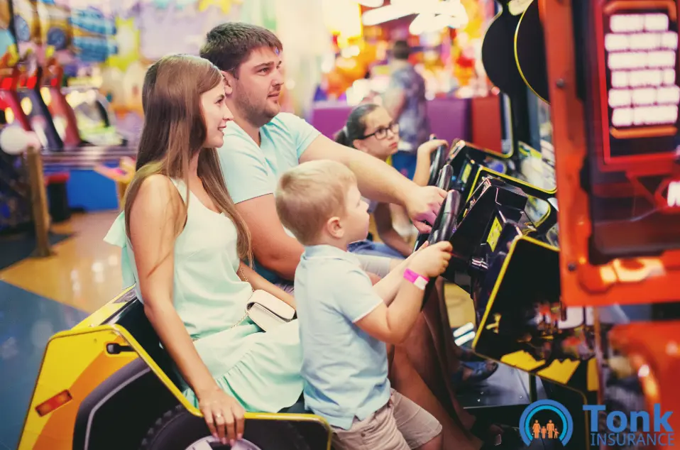 parents playing arcade game with kid